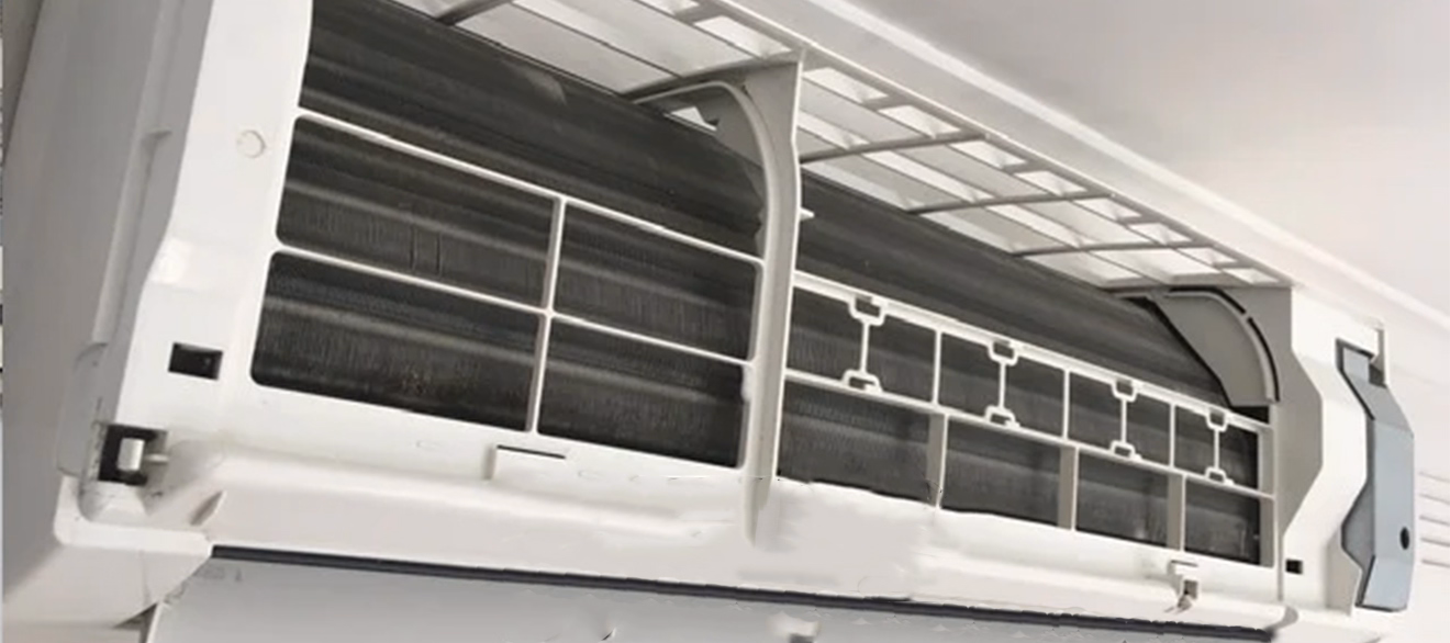 High-Quality Air Conditioner Unit – Efficient Cooling Solutions Modern air conditioner unit installed on a white wall with clear blue sky background
